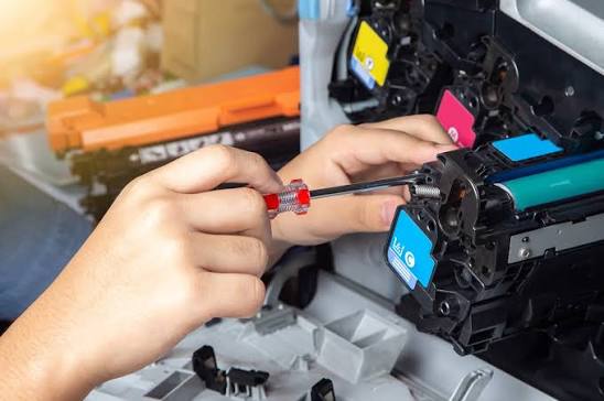 Technician repairing a printer